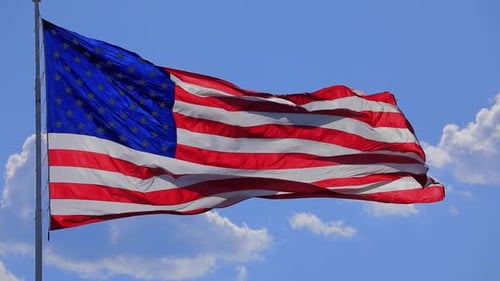 American Flag Waving in Blue Sky