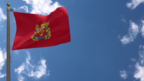 Red Flag with Coat of Arms Waving in Wind