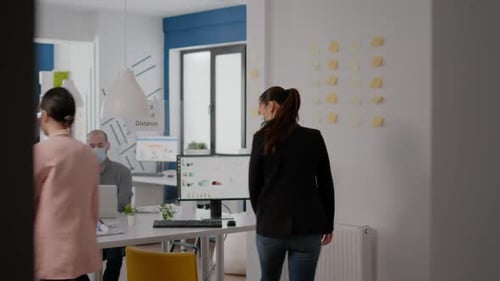 Modern Office Workers Maintaining Social Distancing