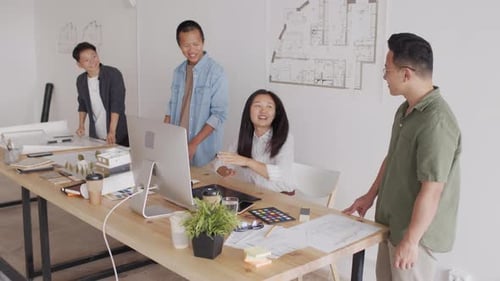 Asian Team of Architects Celebrating Successful Project Delivery