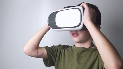 Boy Interacts with a Virtual Reality Headset