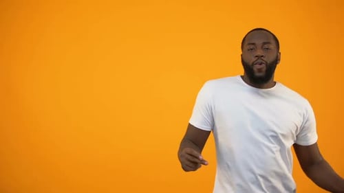 Adult Dancing in Front of Orange Background