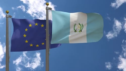 European Union and Guatemala Flags Waving Together in Blue Sky