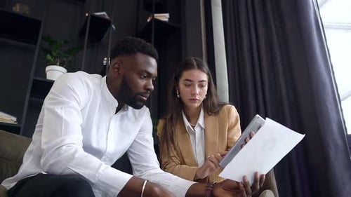 Professionals Work Together on a Project in Office