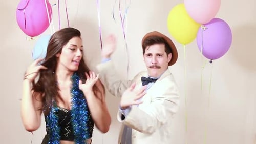 Crazy couple having great time dancing in photo booth