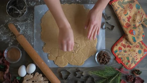 Preparing Holiday Gingerbread Cookies on a Wooden Surface