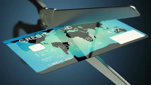 Slow motion animation of a credit card being cut by a pair of scissors. HD