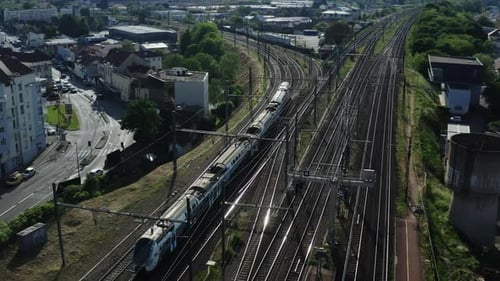 City Passenger Train is Moving on the Track Near the City