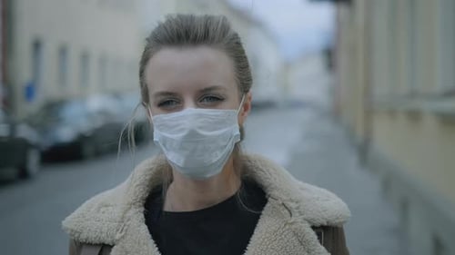 Woman Wearing Face Mask Because of Air Pollution or Virus Epidemic in the City