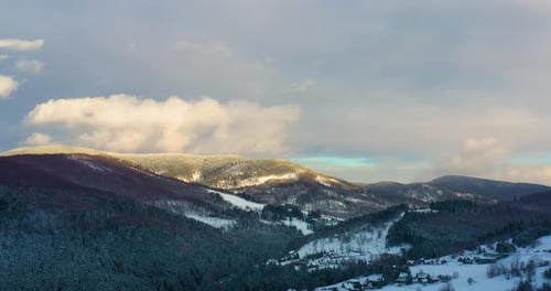 Aerial View of Forest Covered with Snow in Mountains