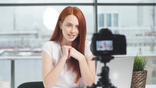 Young Woman Vlogging in Urban Office Setting