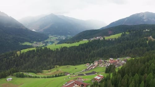 Small Village and Pine Forest in Alps Mountains Valley