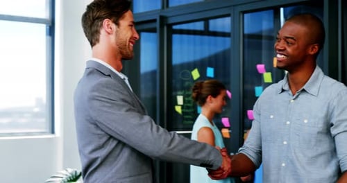 Men Shaking Hands in a Modern Office