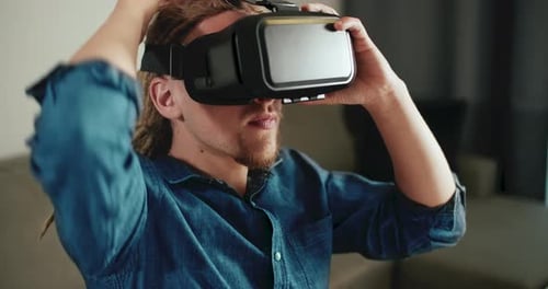 Man Using Virtual Reality Headset at Home