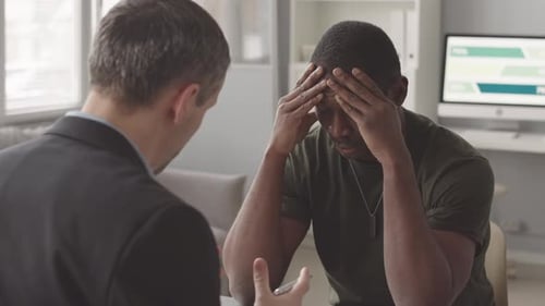 Man in Distress at Office Meeting Receives Water