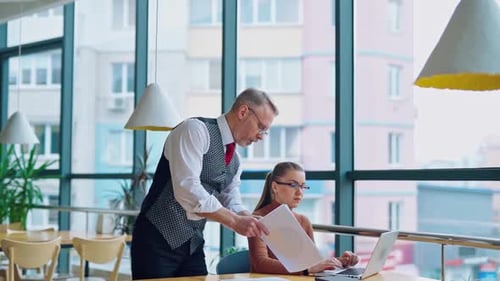 Business Team Collaborating on Laptop in Modern Office