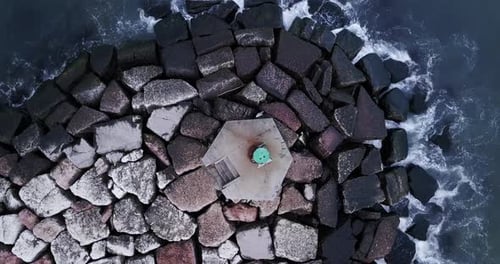 Stones on the Dike in the Middle of the Sea with the Waves