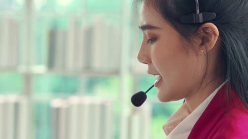 Businesswoman Wearing Headset Working Actively in Office
