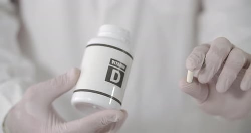 Close Up of Vitamin D Supplement Pill and Bottle