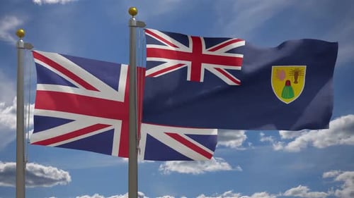 United Kingdom and Turks and Caicos Flags Waving on Flagpoles