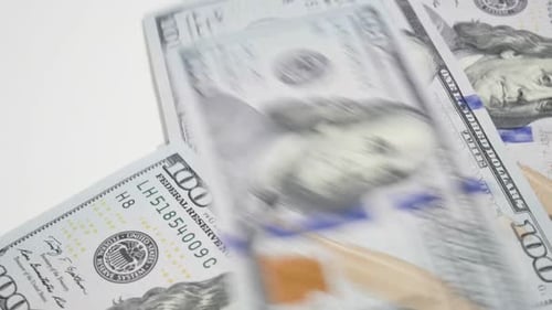 Pile of One Hundred Dollar Bills on White Surface