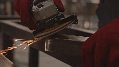 Hands Grinding Metal with Sander