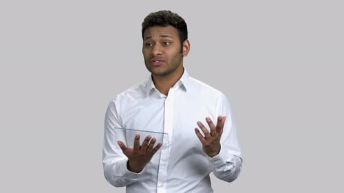 Young Adult Explaining With Glass Tablet