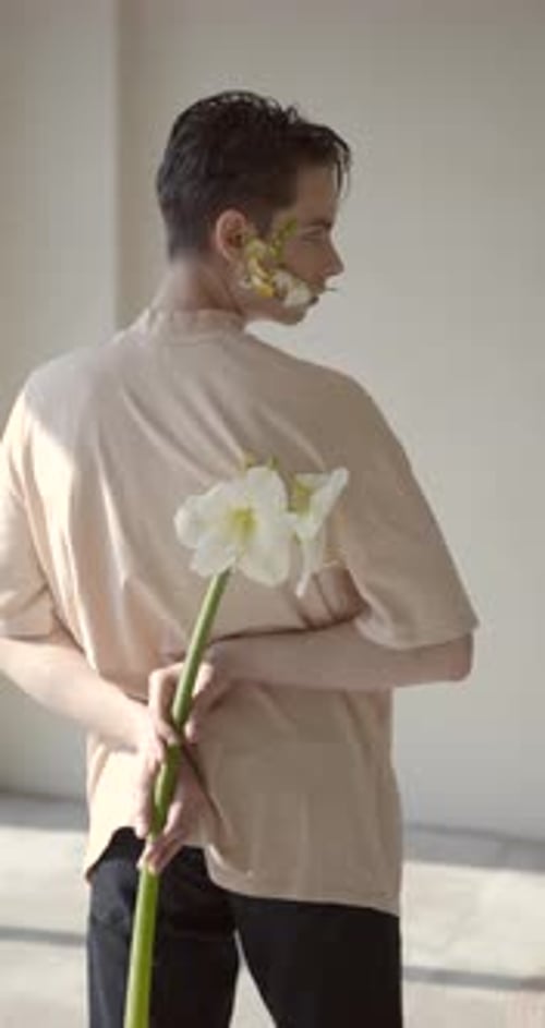 Young Man Posing with a Flower in Studio
