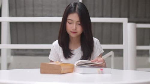 Young Woman Reading a Book Indoors