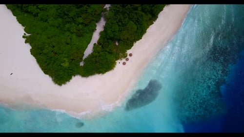 Aerial drone shot seascape of marine island beach trip by shallow ocean and white sand background of