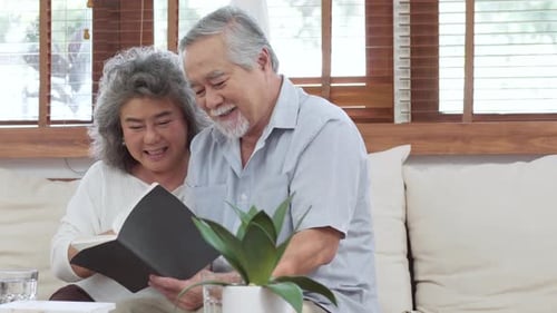 Senior Couple Reading Book Together at Home