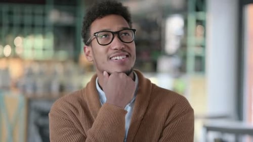 Man Smiles and Thinks in an Office Setting