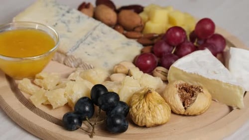 Cheese Board with Grapes, Nuts, and Honey