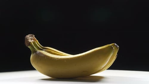 Three Banana Bunch Rotating On black.