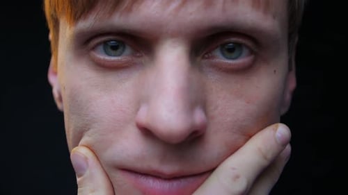 Man Touches His Face