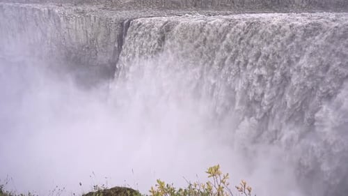 Powerful Waterfall Cascading into a Misty Abyss