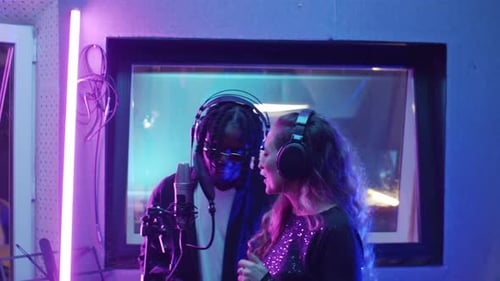 Divers chanteurs enregistrent une chanson ensemble en studio