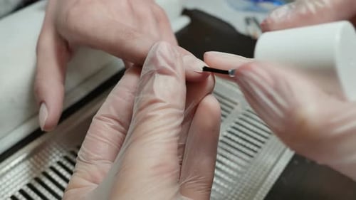 Applying Clear Nail Polish for Manicure Close Up