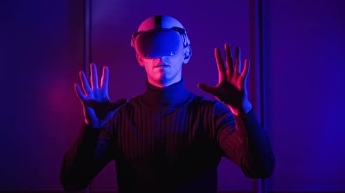 Man Using VR Headset in Neon Lighting