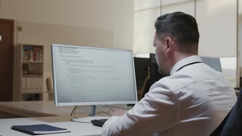 Unrecognizable Man Working On Computer