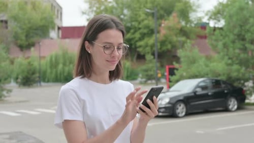 Woman Using Smartphone in Urban Setting