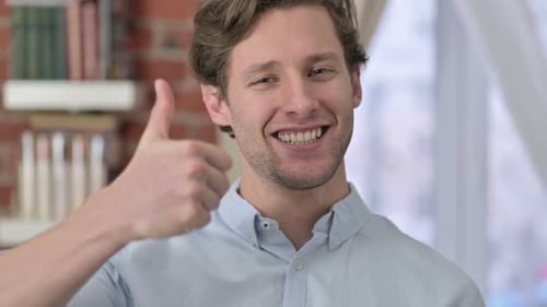 Smiling Man Gives Thumbs Up Gesture
