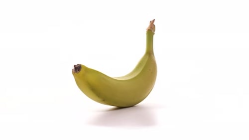 Bright Yellow Banana Rotating on White Background