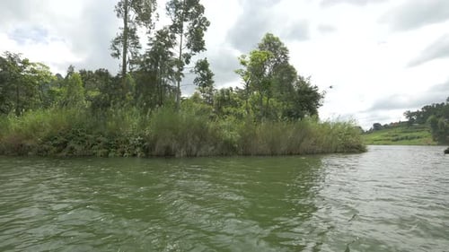 Boat sailing by an island in a lake