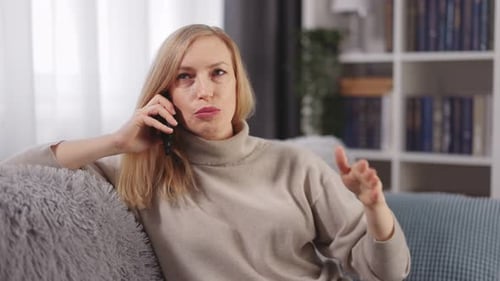 Woman Talking on Mobile Phone in Living Room