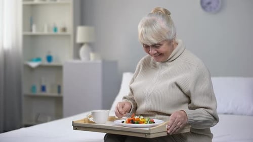 Smiling Old Woman Eating Dinner in Nursing Home, Social Security for Aged People