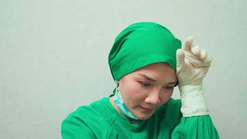 Medical Professional Taking Off Surgical Mask