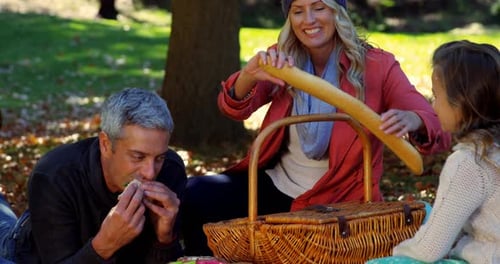 Family Picnic Together in the Park on Autumn Day
