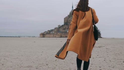 Medium Rear View Shot, Elegant Happy Blogger Woman Walks on Sea Bottom Sand at Epic Mont Saint