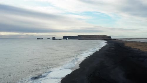 Black Sand Beach And Seashore